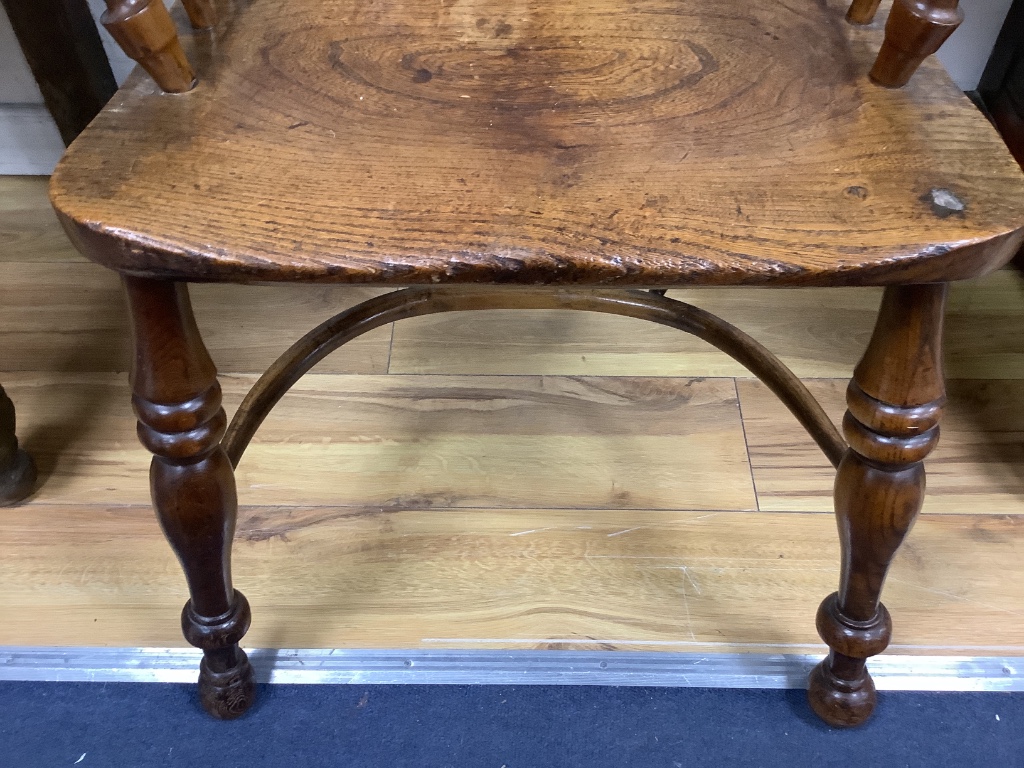 A single early 19th century yew and elm elbow chair